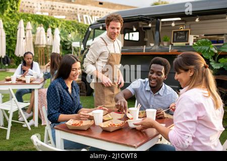 Group of diverse friends having picnic Stock Photo