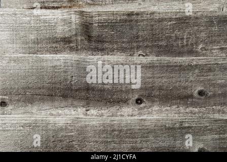 Old weathered grey wooden boards wall closeup as background Stock Photo