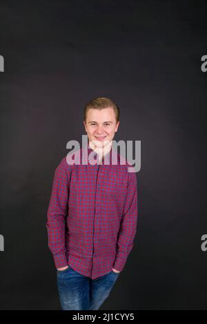 portrait of cute smiling sixteen year old boy in studio Stock Photo