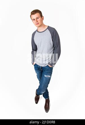 African boy poses in front of camera with beautiful smile and crossed arms.  Studio portrait on white background Stock Photo - Alamy