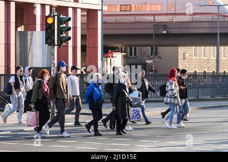 Berlin, Germany. 24th Mar, 2022. People cross a street in Berlin, capital of Germany, on March 24, 2022. Germany's daily number of COVID-19 infections exceeded 300,000 for the first time since the start of the pandemic, the Robert Koch Institute (RKI) for infectious diseases said on Thursday. Credit: Stefan Zeitz/Xinhua/Alamy Live News Stock Photo