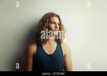 Daydreamer. A handsome trendy young man wearing a vest. Stock Photo