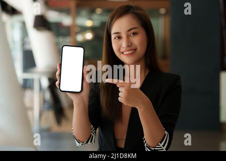 Woman showing smartphone with blank screen for advertise. Stock Photo