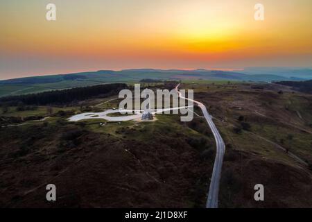 Portesham, Dorset, UK.  24th March 2022.  UK Weather.  View from the air of Hardy Monument on Black Down near Portesham in Dorset at sunset at the end of a hot sunny spring day.  Picture Credit: Graham Hunt/Alamy Live News Stock Photo