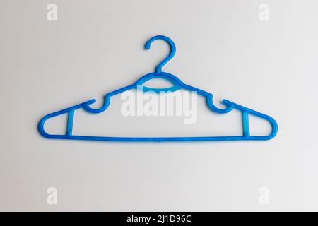 Blue plastic hanger on white background Stock Photo