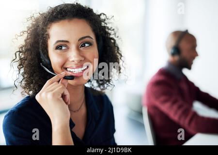 That sounds like something we can help you with. Cropped shot of an attractive young female call center agent looking thoughtful while working in her Stock Photo