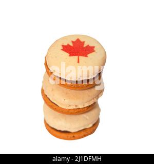 Stack of maple macarons decorated with red maple leaf made for Canada Day celebration, cut out Stock Photo