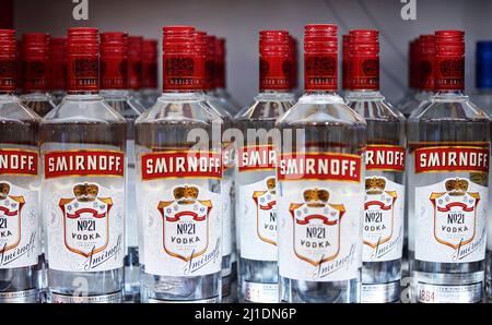 Russian vodka. Bottles of Smirnoff vodka on a shelf in duty free shop in Dubai Airport. Traditional Russian souvenir. 12,02,2022, Dubai, UAE Stock Photo