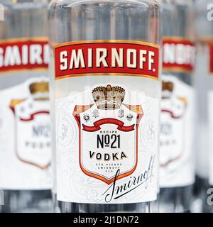 Russian vodka. Bottles of Smirnoff vodka on a shelf in duty free shop in Dubai Airport. Traditional Russian souvenir. 12,02,2022, Dubai, UAE Stock Photo