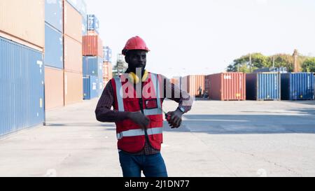 Cargo container worker thumbs up at cargo port Stock Photo - Alamy