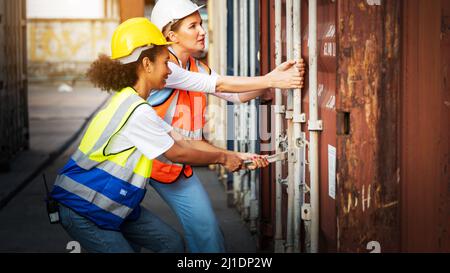 Woman CEO and African american Woman foreman or inspector suppervisor open the cargo door for checking concept import export shipping  transportation Stock Photo