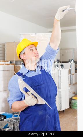Plasterer working indoors Stock Photo