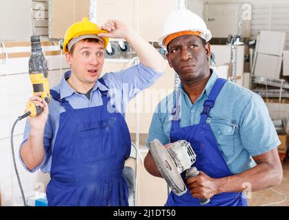 Surprised contractors with power tools Stock Photo