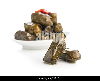 Dolmades. Stuffed vine leaves. Greek appetizer on plate isolated on a white background. Stock Photo