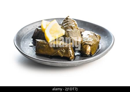 Dolmades. Stuffed vine leaves. Greek appetizer on plate isolated on a white background. Stock Photo