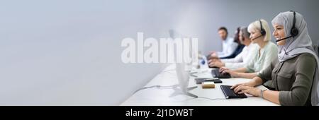 Positive Female Customer Services Agent With Headset Working In A Call Center Stock Photo