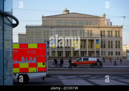 An ambulance stands on Augustusplatz in Leipzig. The Leipzig Opera House is in the background. Stock Photo