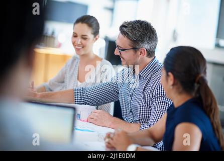 Planning their next move. Shot of a group of businesspeople in a meeting. Stock Photo