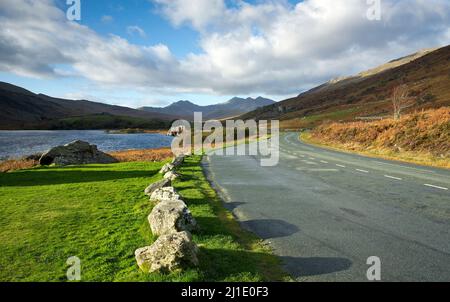 Photograph of Llyn Mymbyr with distant views of the Snowdon range of mountains in Snowdonia National Park Gwynedd North Wales United Kingdom Europe Stock Photo