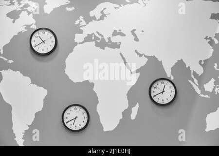 Clocks in a world map. Global time. Travel and geography Stock Photo