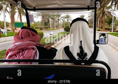 19.02.2021, Saudi Arabia, Riyadh, Riad - Local men sitting in an electric caddie. 00S210219D086CAROEX.JPG [MODEL RELEASE: NO, PROPERTY RELEASE: NO (c) Stock Photo