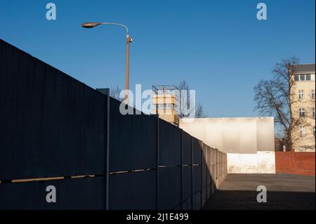 06.01.2022, Germany, , Berlin - The memorial of the Berlin Wall with a border tower, concrete wall segments and a steel wall along Bernauer Strasse in Stock Photo