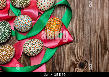 Colorful Easter Eggs and ribbons banner.Above view with copy space for text.Happy Easter decoration background,hand painted decorated eggs.Spring fest Stock Photo