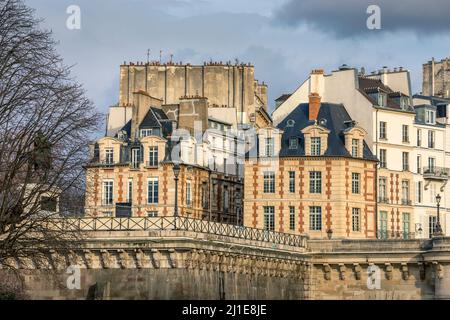 Paris, France - March 14, 2021: Beautiful Haussmann building near Place Dauphine and Pont Neuf bridge in Paris Stock Photo