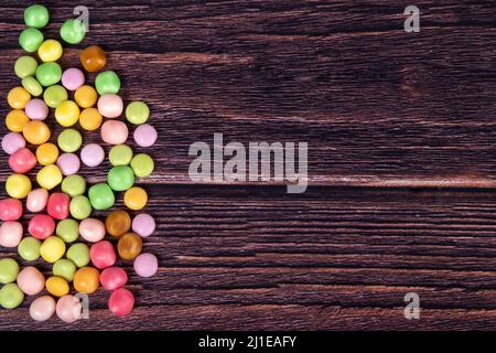 Multicolor candies on a wooden background Stock Photo