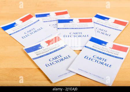 France, Paris, March 22, 2022, French electoral voter cards official government allowing to vote paper on wooden background, France Stock Photo