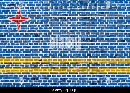 Close-up on a brick wall with the flag of Aruba painted on it. Stock Photo