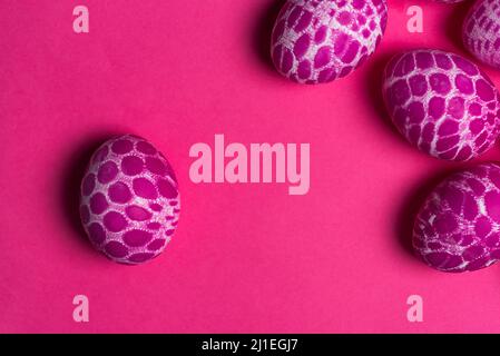 Lace pattern painted pink Easter eggs with copy space on pink background top view. Easter holiday abstract background Stock Photo