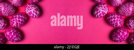 Lace pattern painted pink Easter eggs with copy space on pink background top view. Easter holiday abstract background with wide copy space banner Stock Photo