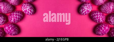 Lace pattern painted pink Easter eggs with copy space on pink background top view. Easter holiday abstract background with wide copy space banner Stock Photo