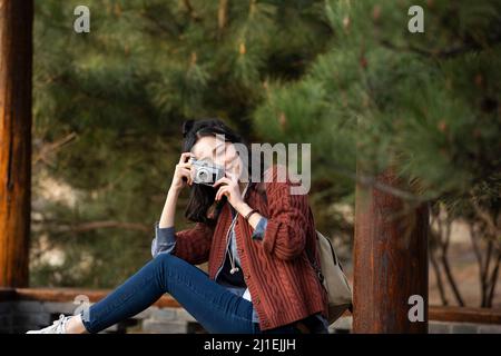 Young female college student practicing photography - stock photo Stock Photo