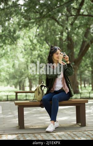 Female tourist taking photo in the forest park - stock photo Stock Photo