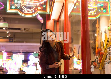Young Chinese college girl feeling curious about Peking Opera costumes and headdresses - stock photo Stock Photo