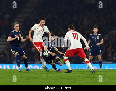 Hampden Park, Glasgow.Scotland UK. Thursday, 24 March 22. International Friendly Scotland v Poland. Little big man Billy Gilmour of Scotland takes on Jakub Moder & Grzegorz Krychowiak Poland Credit: eric mccowat/Alamy Live News Stock Photo