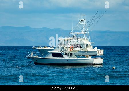 Motor boat anchored on Ocotal beach, view of Pacific ocean, El Coco Costa Rica. Pura Vida concept, travel to exotic tropical country. Stock Photo