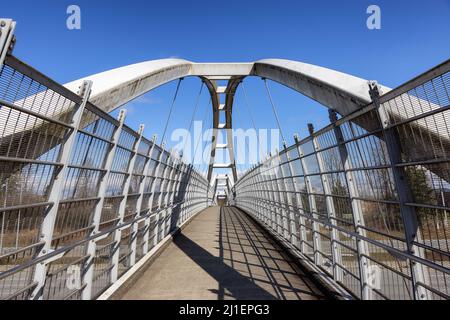 Pedestrian bridge across Trans Canada Highway in modern city suburbs Stock Photo