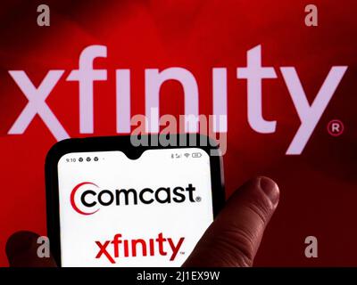 In this photo illustration, the Comcast Cable (Xfinity) logo is displayed on a smartphone screen with a Xfinity logo in the background. (Photo by Igor Golovniov / SOPA Images/Sipa USA) Stock Photo