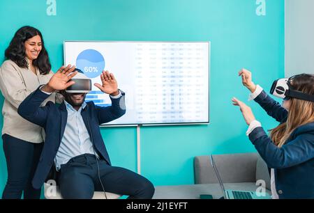 Multiracial business people using virtual reality glasses technology - Metaverse concept Stock Photo
