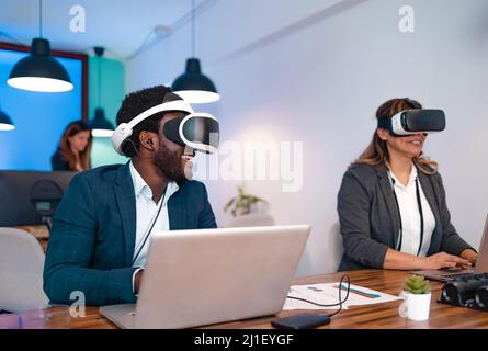 Business people wearing virtual reality glasses while working in modern creative space Stock Photo