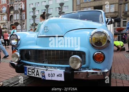BYTOM, POLAND - SEPTEMBER 12, 2015: People walk by FSO Warszawa during 12th Historic Vehicle Rally in Bytom. The annual vehicle parade is one of main Stock Photo