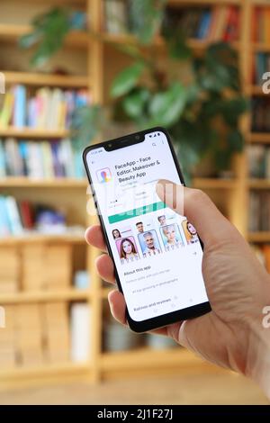 WARSAW, POLAND - JANUARY 29, 2021: User installing Faceapp beauty and makeover app on an Android OS, Xiaomi brand smart phone. Stock Photo