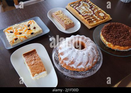 Easter cakes table in Poland. Easter pastry: baba cake, mazurek cakes and cheesecakes. Easter in Poland - Wielkanoc. Stock Photo