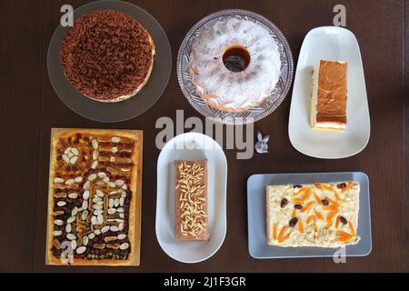 Easter cakes table in Poland. Easter pastry: baba cake, mazurek cakes and cheesecakes. Easter in Poland - Wielkanoc. Stock Photo