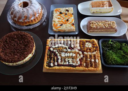 Easter cakes table in Poland. Easter pastry: baba cake, mazurek cakes and cheesecakes. Easter in Poland - Wielkanoc. Stock Photo