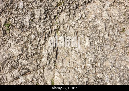 Fractured surface of an outcropping of rock, background, pattern, texture. Stock Photo