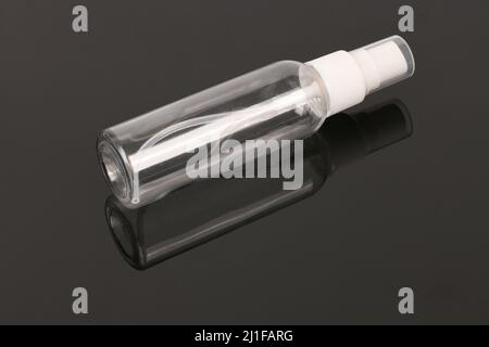 Blank pocket spray bottle with cap isolated on black. High resolution photo. Full depth of field. Stock Photo